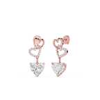 Rose gold heart-shaped earrings with clear gemstones on a white background