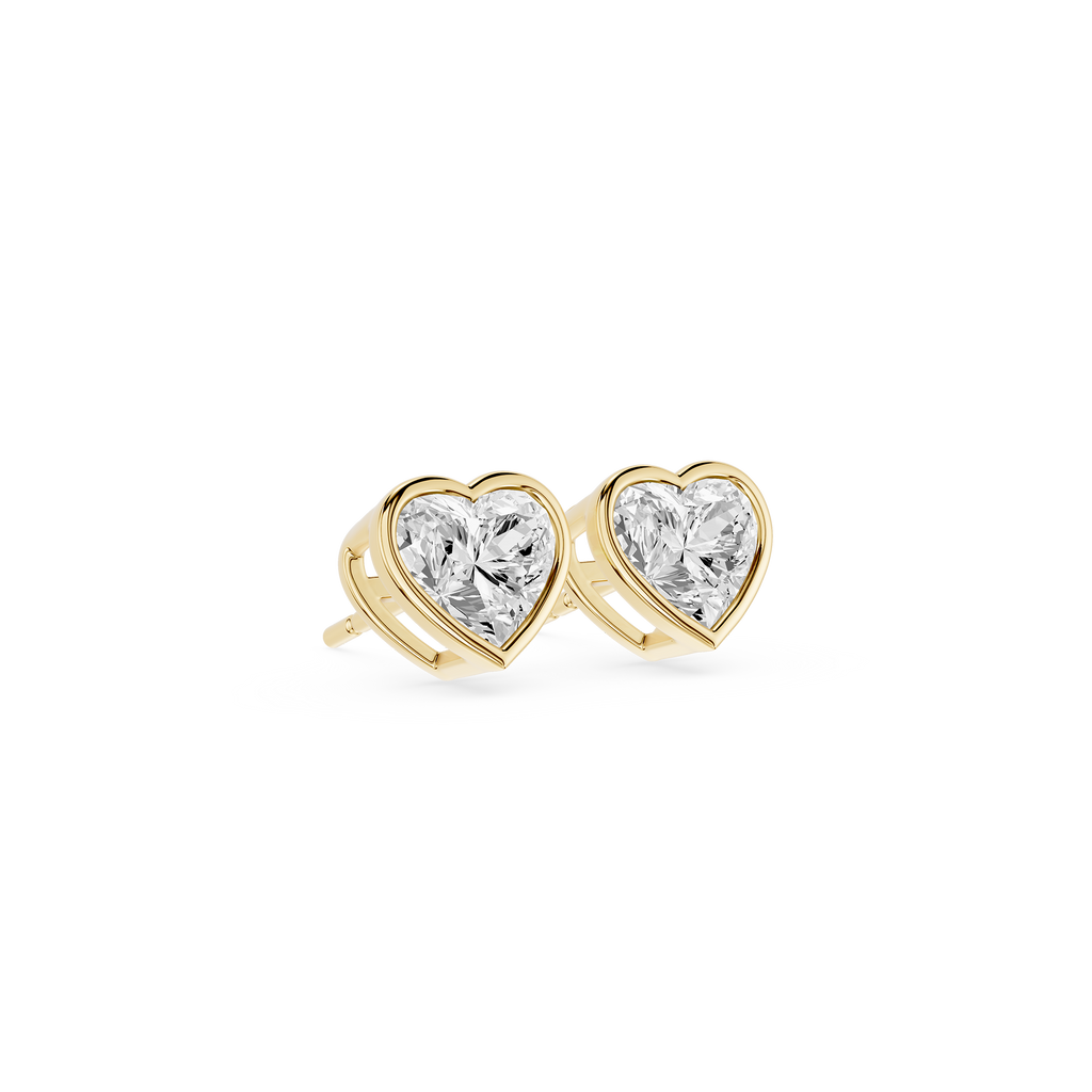 Heart-shaped diamond earrings with gold settings on a white background