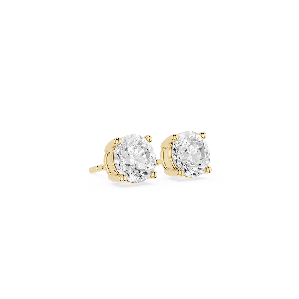 Gold stud earrings with clear gemstones on a white background