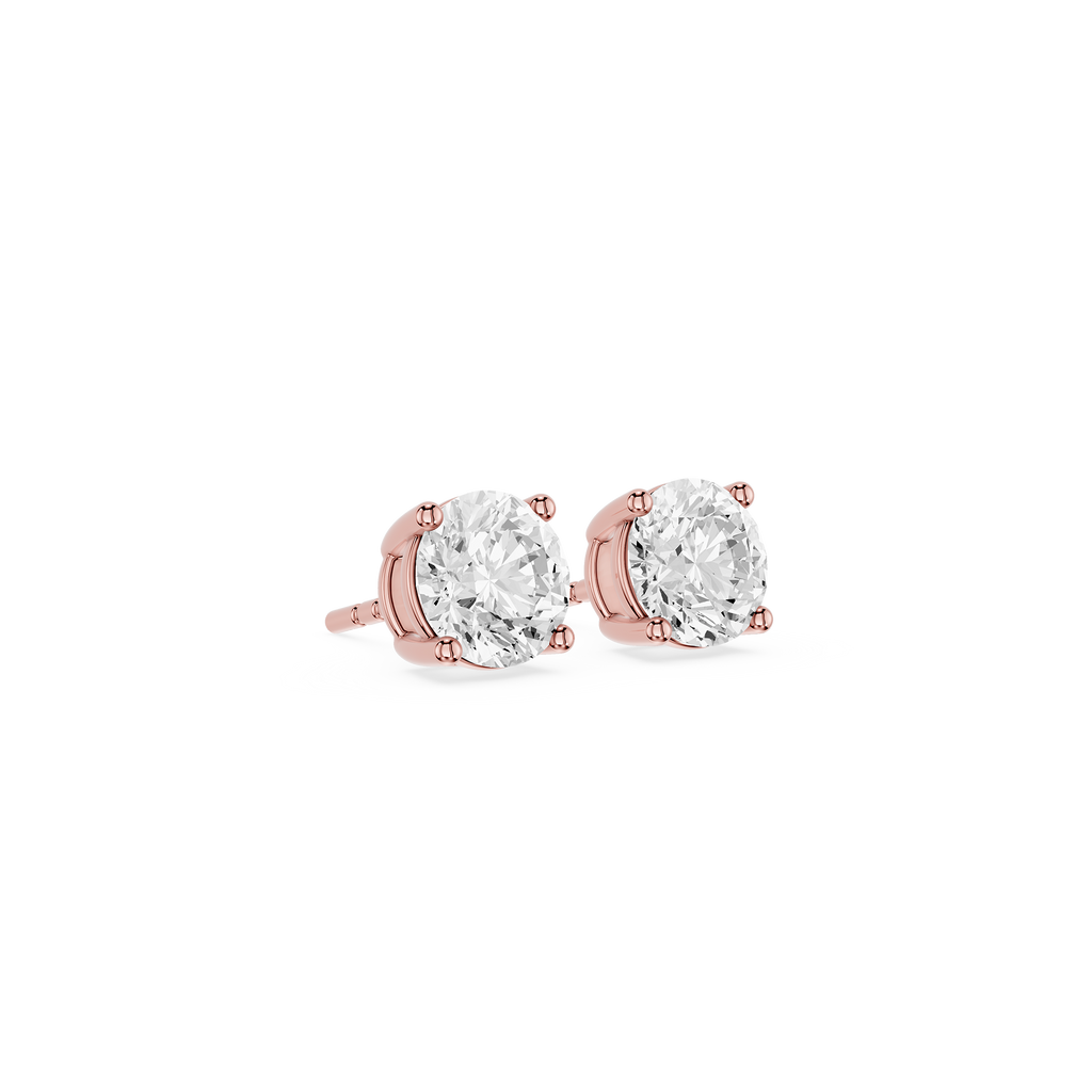 Rose gold earrings with clear gemstones on a white background