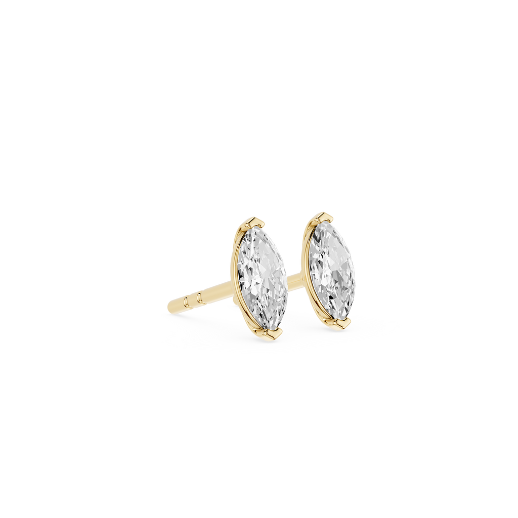 Gold earrings with clear gemstones on a white background