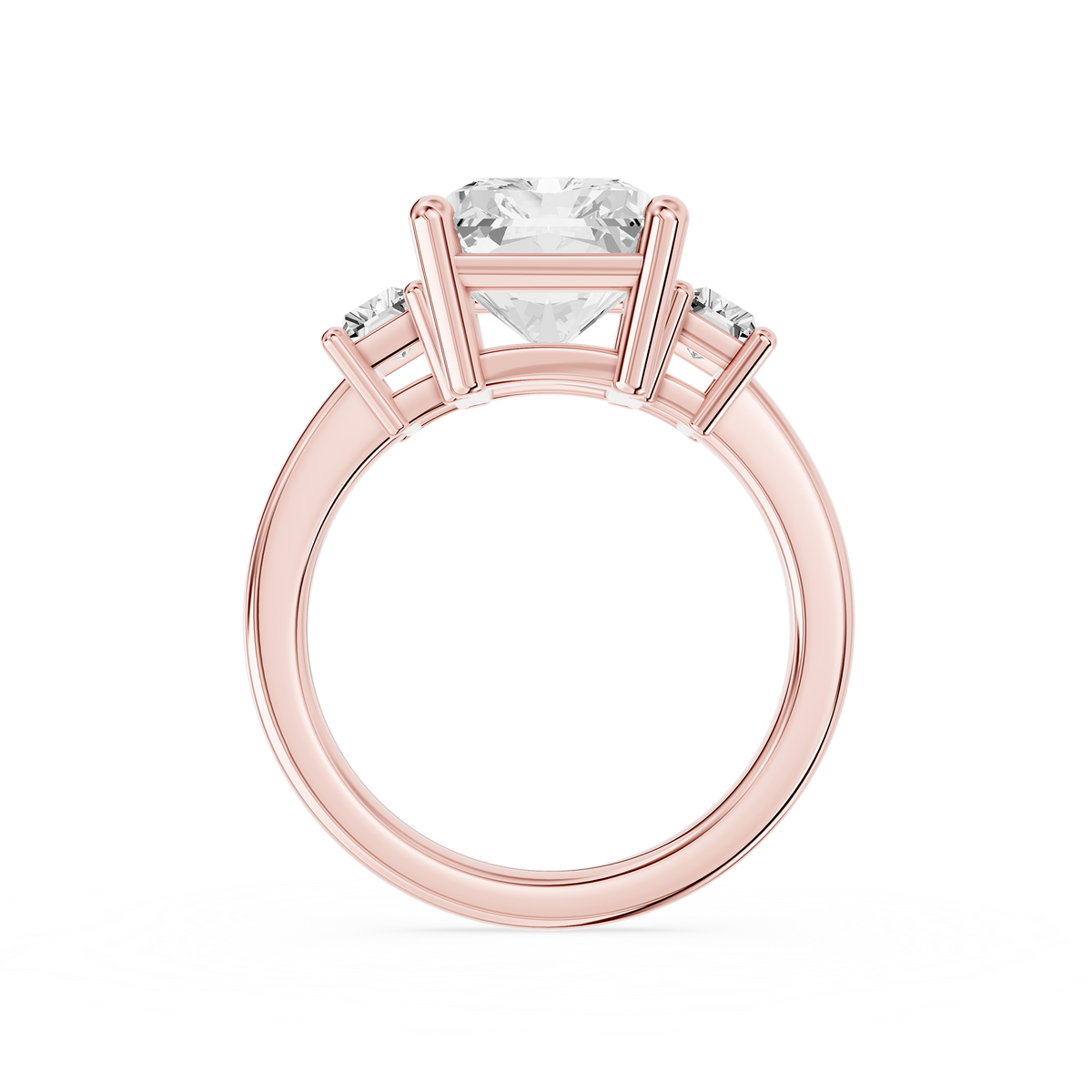 A large radiant cut lab diamond rests between two baguette side diamonds on this rose gold ring with a polished shank