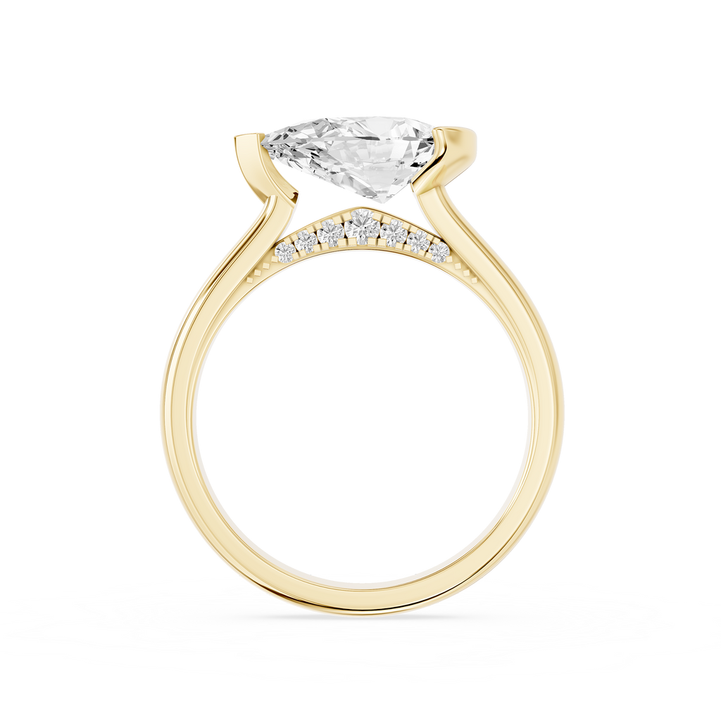 A pear cut diamond sits sideways across this yellow gold engagement ring, secured by an asymmetrical partial bezel setting