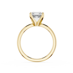 Gold ring with a clear gemstone on a white background