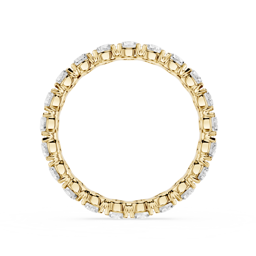 A yellow gold eternity ring featuring a continuous line of round-cut clear gemstones in a prong setting, shown against a plain white background.