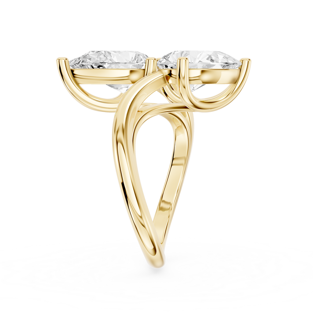 Two pear shaped lab diamonds sit in a diagonal arrangement on this yellow gold engagement ring with an open shank design
