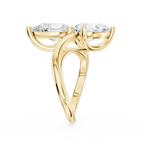 Two pear shaped lab diamonds sit in a diagonal arrangement on this yellow gold engagement ring with an open shank design