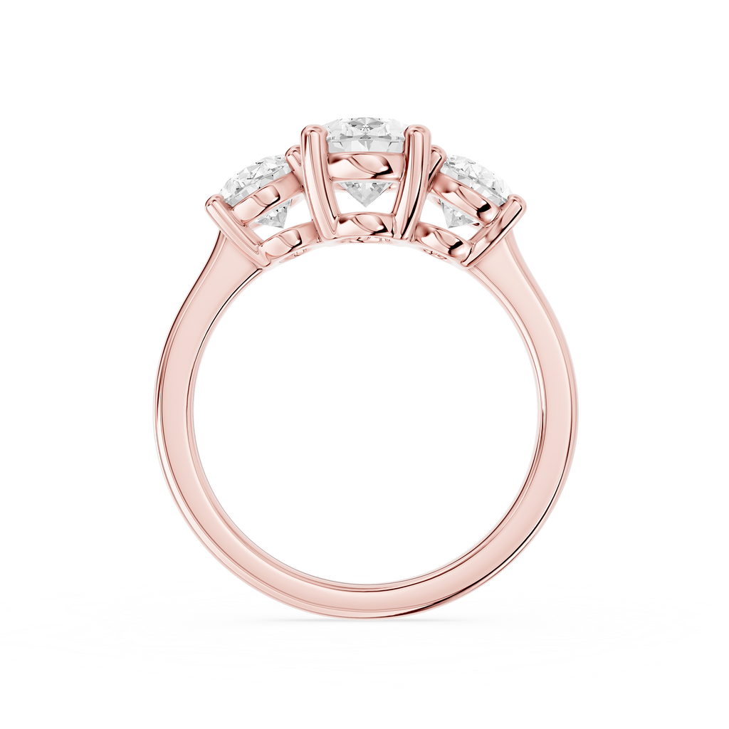 Three oval cut lab diamonds arranged in graduated sizes across a rose gold band with individual claw prong settings