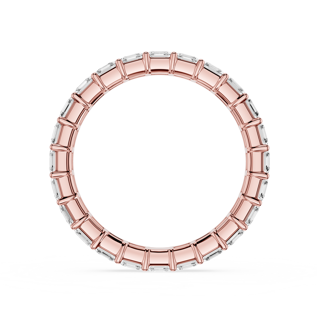 A wide rose gold eternity-style ring with rectangular clear stones set around the band, shown on a plain white background.