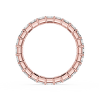 A wide rose gold eternity-style ring with rectangular clear stones set around the band, shown on a plain white background.