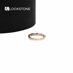 Rose gold diamond anniversary ring with alternating step cut baguette stones and round diamonds in a fine setting