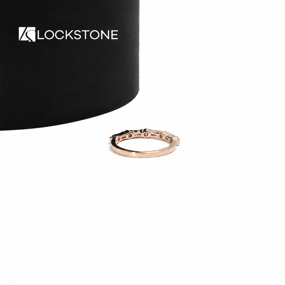 Rose gold diamond anniversary ring with alternating step cut baguette stones and round diamonds in a fine setting