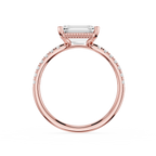 A rose gold engagement ring featuring a rectangular emerald-cut clear center stone and pavé-set round diamonds along the shank, shown on a clean white background.