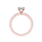 A Rose-toned diamond ring featuring a rectangular cushion-cut center stone in a four-prong setting, with a halo of small round diamonds along the band, shown against a plain white background.