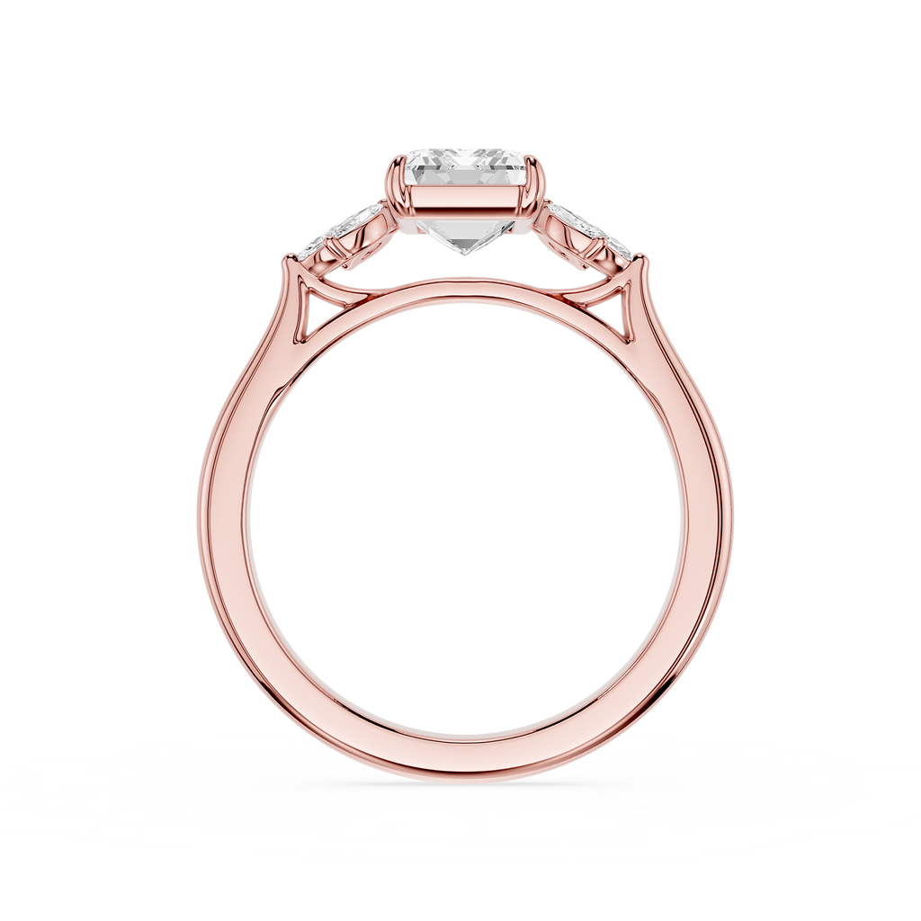 A rose gold ring with a heart-shaped clear gemstone in the center and smaller side stones, shown on a plain white background.