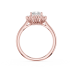 A rose gold ring with a unique prong setting holding a clear round gemstone, shown on a solid white background.