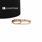 A rose gold diamond wedding band with a repeating pattern of heart, round and emerald cut stones in smooth bezel settings