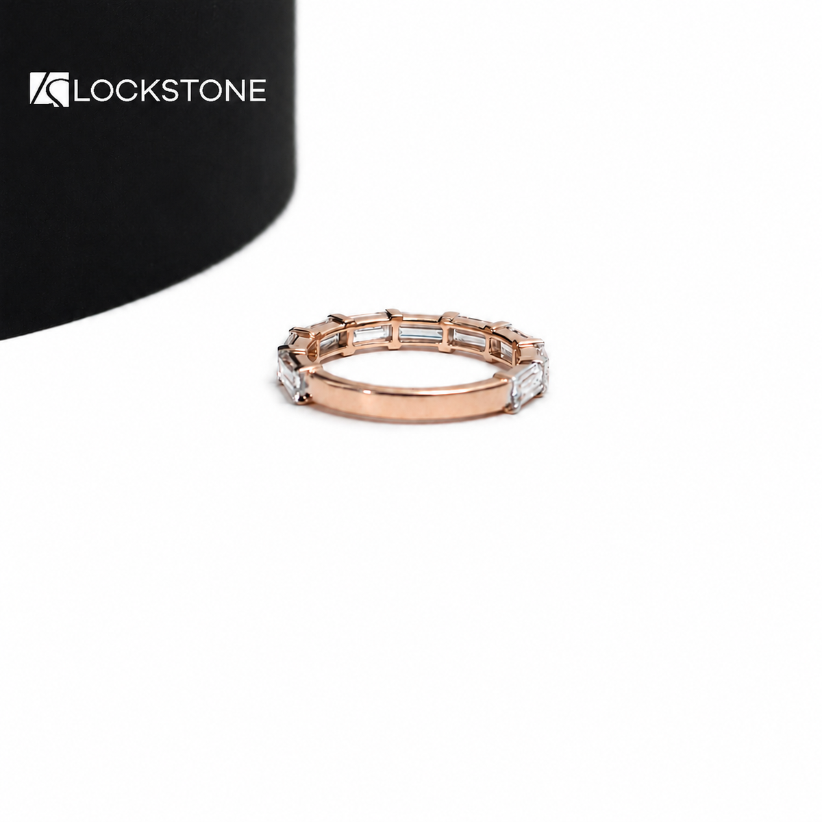 Baguette diamond stacking ring in rose gold displaying a continuous front row of horizontally placed step cut stones