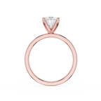 A rose gold solitaire engagement ring with a triangular-cut clear gemstone, shown on a plain white background.