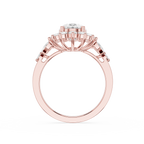 A rose gold ring with a large round-cut center stone and smaller side stones, shown from a top-down view on a plain white background.