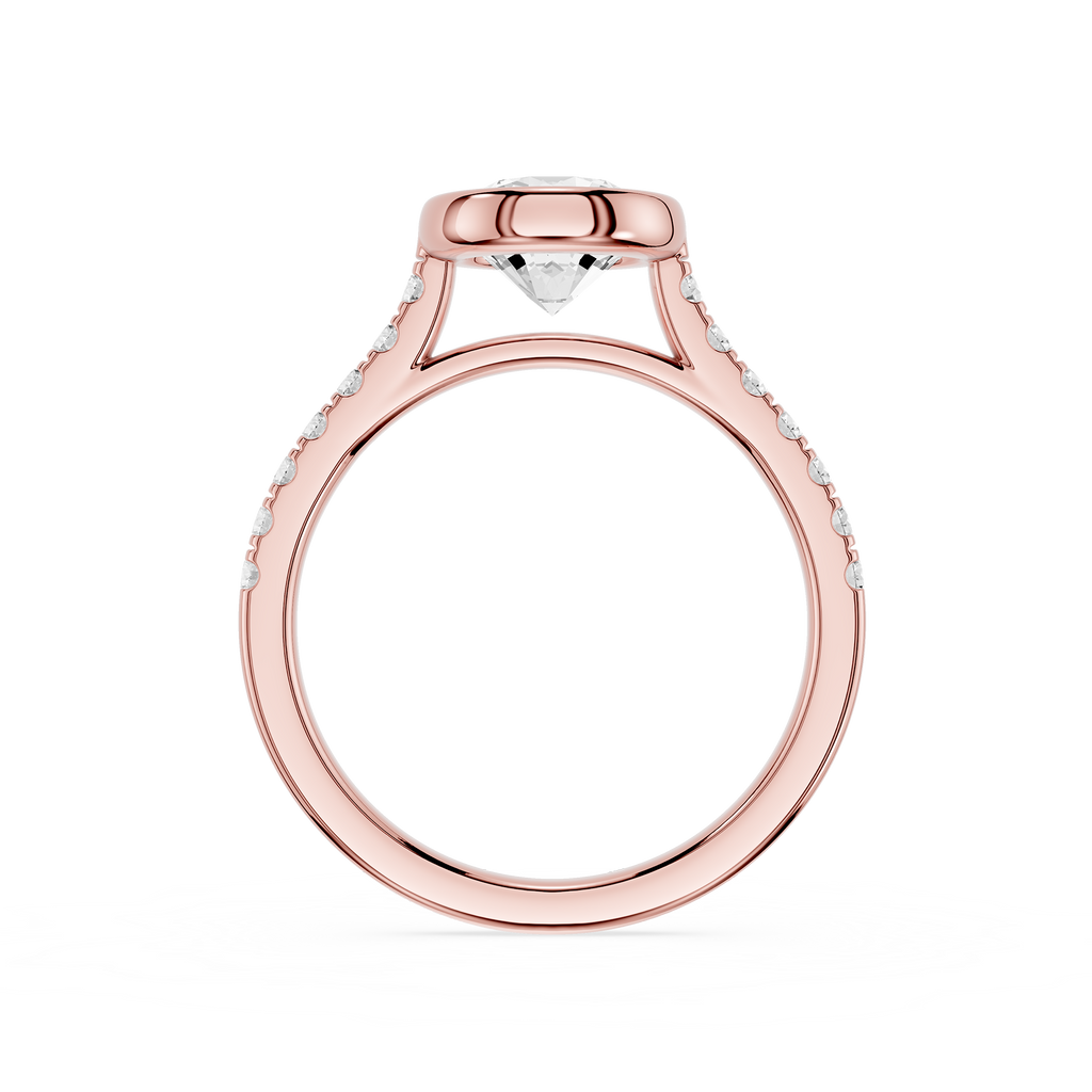 A rose gold engagement ring with a round bezel setting, featuring a central diamond and small pavé diamonds along the shoulders, shown on a plain white background.