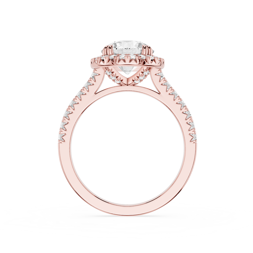 A rose gold engagement ring featuring a round-cut center stone and a halo of small pavé-set stones along the shoulders, shown on a plain white background.