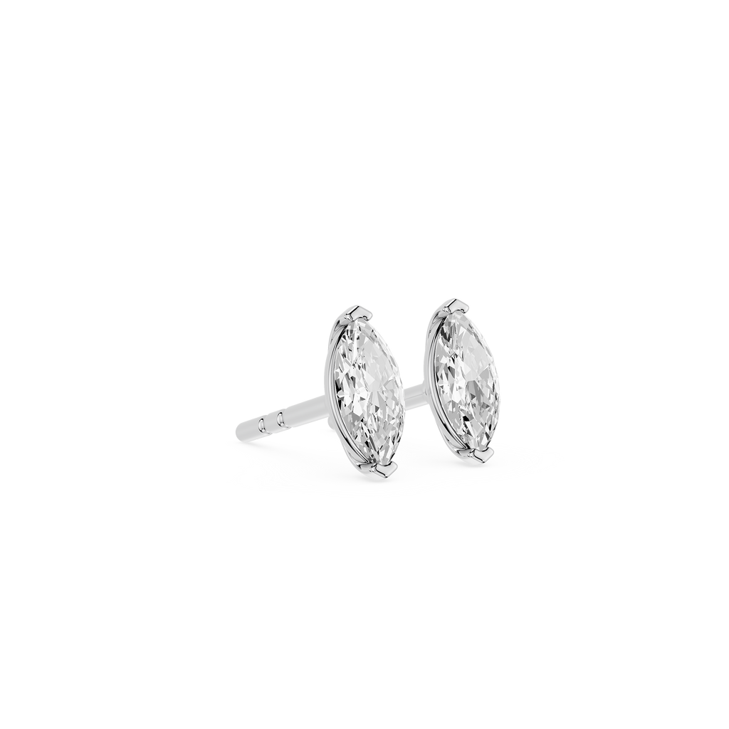 Pair of silver earrings with clear gemstones on a white background