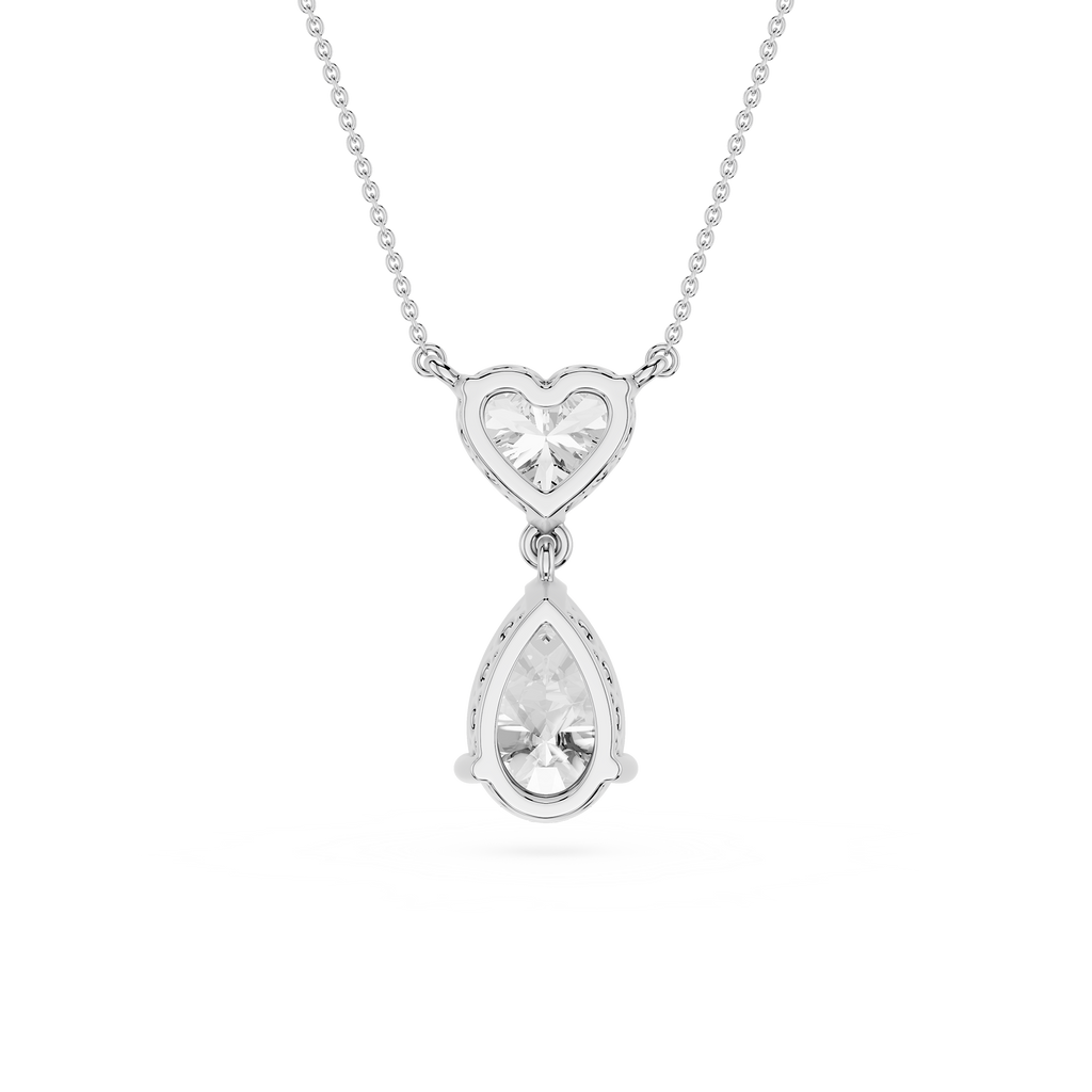 Silver necklace with heart and teardrop pendant on a white background