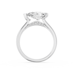 A crescent shaped metal bezel wraps one end of the horizontal pear diamond on this polished white gold solitaire ring