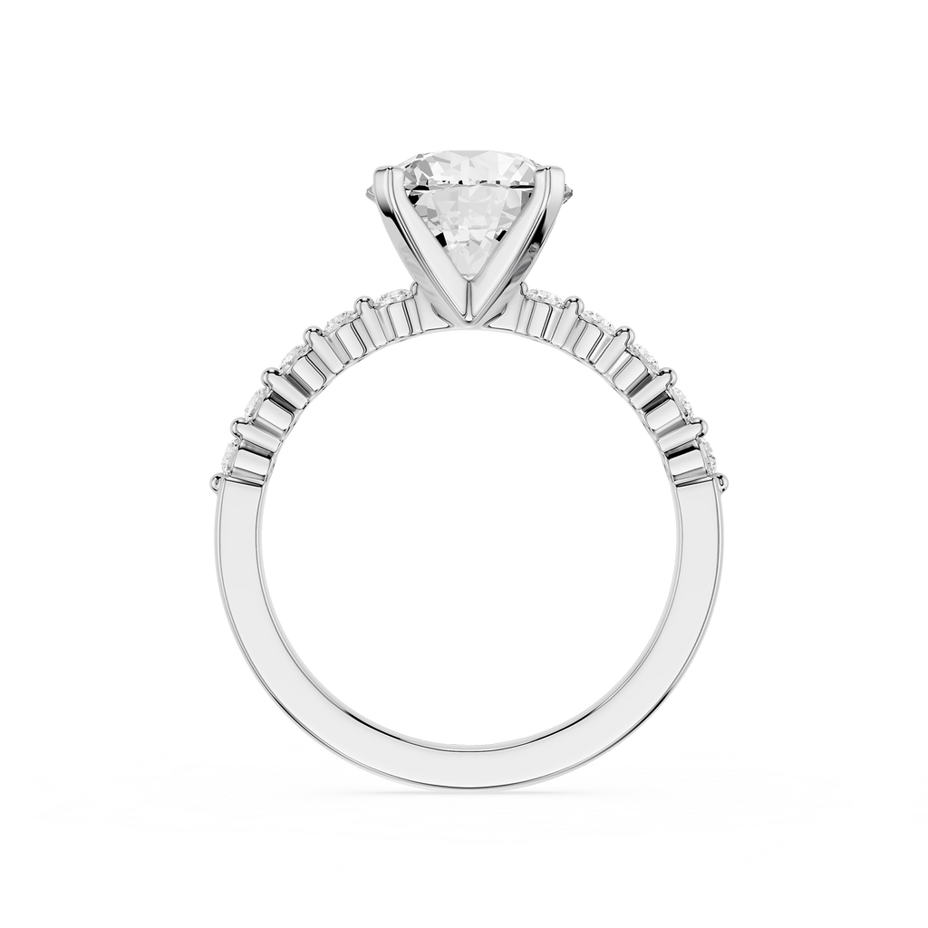 A silver-toned solitaire engagement ring featuring a large round-cut diamond center stone in a four-prong setting, with a shank accented by small baguette diamonds, shown on a plain white background.