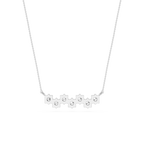 Silver necklace with small round pendants on a white background