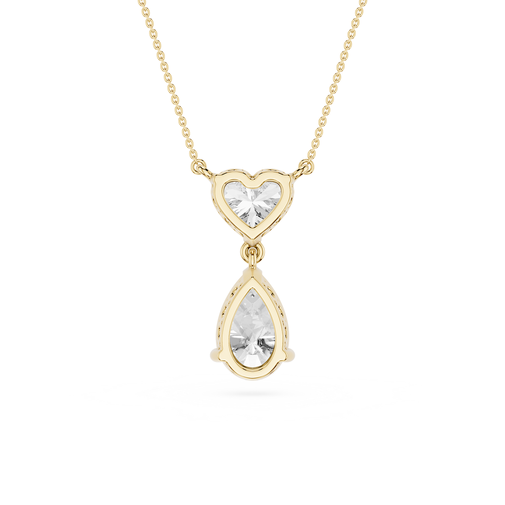 Gold necklace with a heart-shaped top and teardrop-shaped bottom pendant on a white background