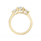 Oval diamond trilogy engagement ring in yellow gold displaying a prominent center stone flanked by two smaller oval diamonds
