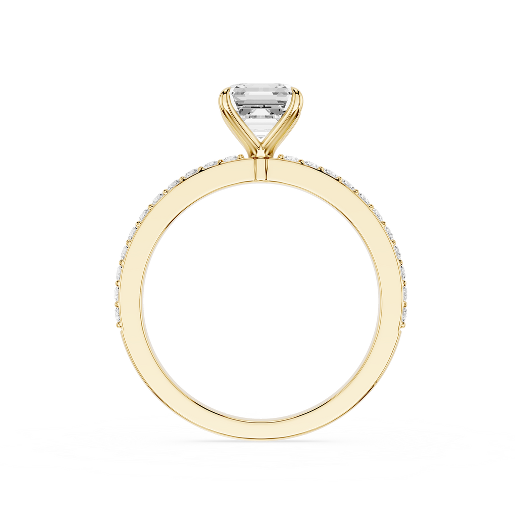 A yellow gold ring featuring a single rectangular clear gemstone in a prong setting, with a pavé band of small round diamonds, shown on a plain white background.