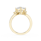 A yellow gold ring with a large round-cut center stone and smaller stones along the band, shown on a plain white background.
