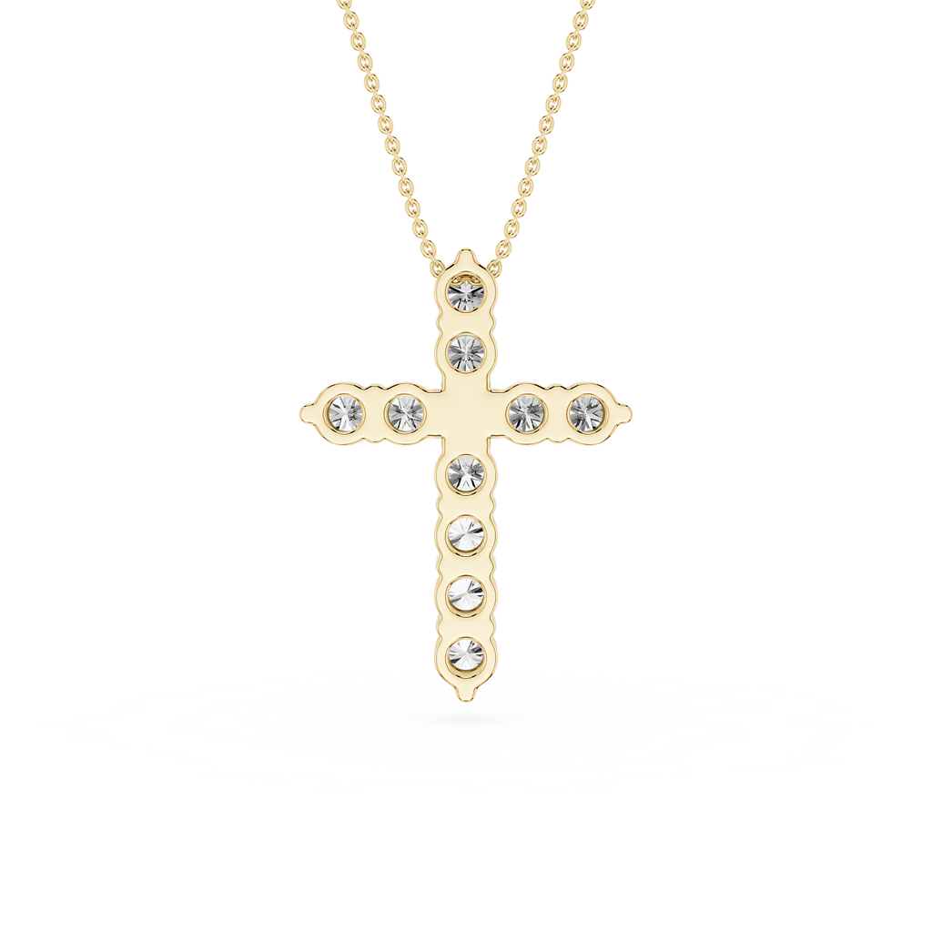 Gold cross necklace with clear stones on a white background