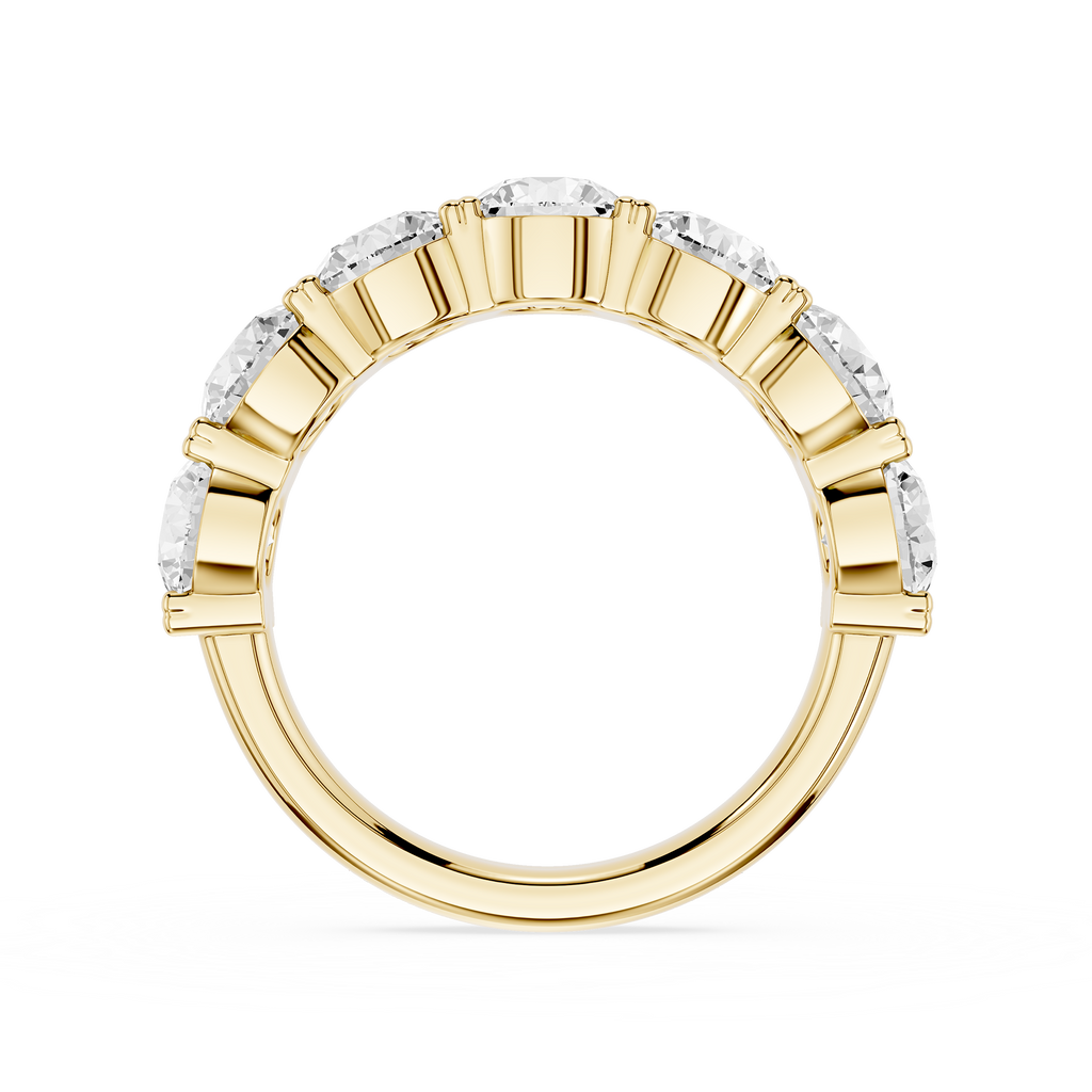 A yellow gold eternity ring featuring a continuous row of round brilliant-cut diamonds in a beveled setting, shown against a solid white background.