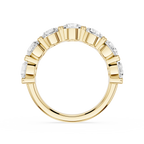 A yellow gold eternity ring featuring a continuous row of round brilliant-cut diamonds in a beveled setting, shown against a solid white background.