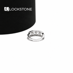 An openwork yellow gold diamond statement band showcasing spaced round diamonds between parallel pavé accented edges