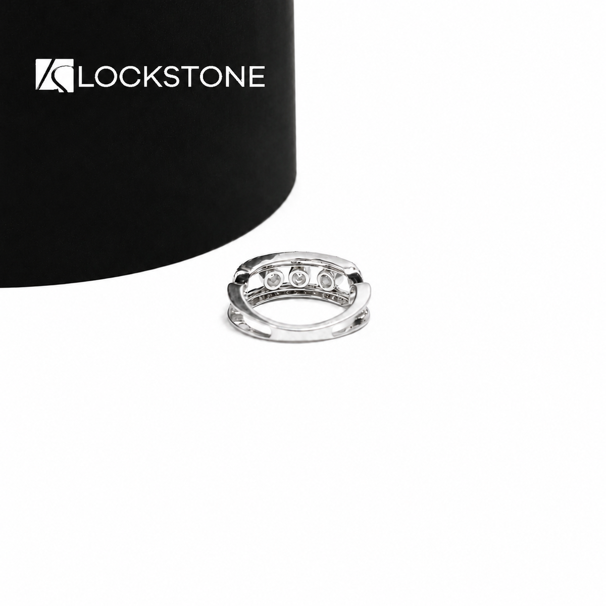 An openwork yellow gold diamond statement band showcasing spaced round diamonds between parallel pavé accented edges