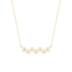 Gold necklace with a bar pendant featuring cut-out sections and small diamonds on a white background