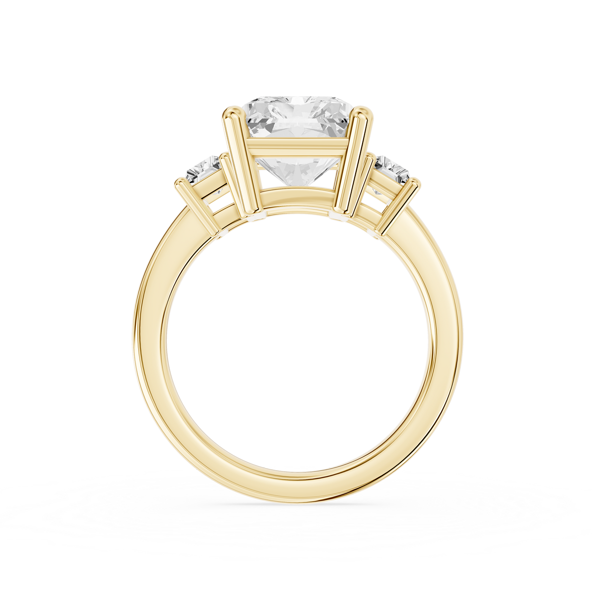 A prong set radiant lab diamond sits between step cut side diamonds on this yellow gold three stone engagement ring