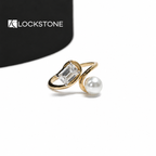 Yellow gold emerald cut lab grown diamond and pearl Toi et Moi ring featuring an open bypass band and two stone setting