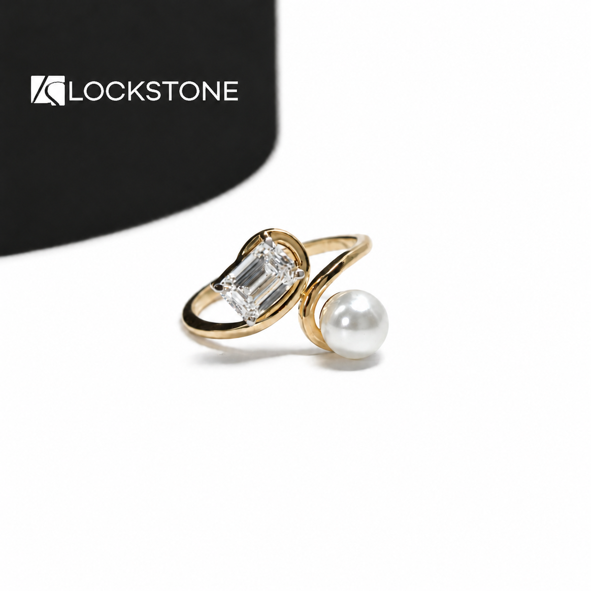 Yellow gold emerald cut lab grown diamond and pearl Toi et Moi ring featuring an open bypass band and two stone setting