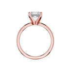 Rose gold ring with a clear gemstone on a white background