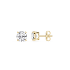 Gold earrings with clear gemstones on a white background