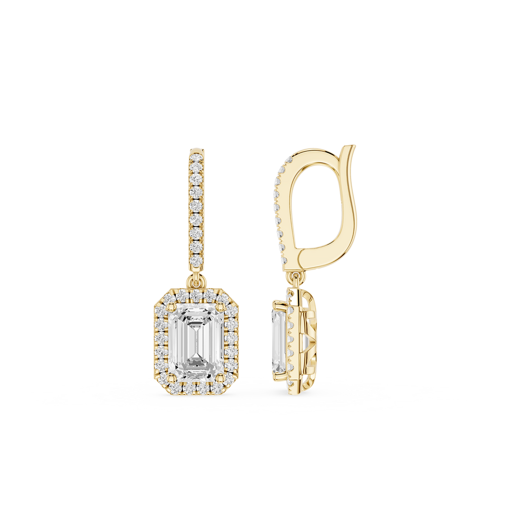 Gold earrings with emerald-cut gemstones on a white background