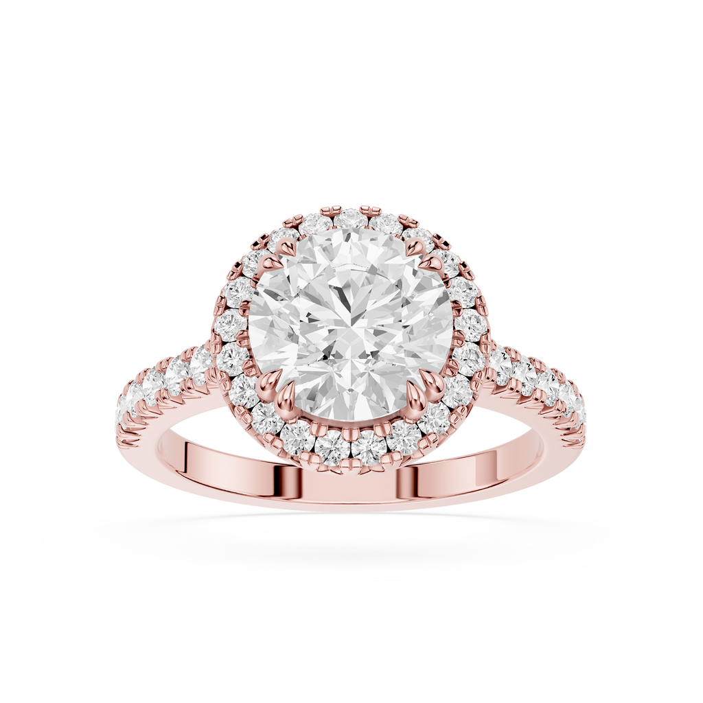 A Rose-toned diamond engagement ring featuring a large round center stone in a halo setting, with a Pave band, shown on a plain white background.