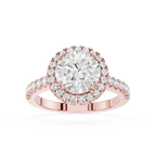 A Rose-toned diamond engagement ring featuring a large round center stone in a halo setting, with a Pave band, shown on a plain white background.