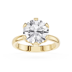 Gold ring with a large diamond on a white background